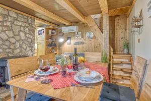 a table with plates and wine glasses on it at Fani's Riverside Cottage - Happy Rentals in Kostel