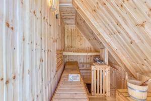 a wooden interior of a sauna with a wooden floor at Fani's Riverside Cottage - Happy Rentals in Kostel