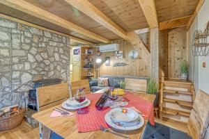 comedor con mesa y pared de piedra en Fani's Riverside Cottage - Happy Rentals, en Kostel