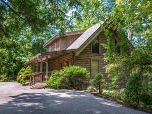 a log cabin with a driveway in front of it at Buckhorn, 2 Bedrooms, Sleeps 6, WiFi, Jetted Tub, Fireplace, Hot Tub in Gatlinburg