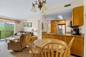 a kitchen and living room with a table and chairs at Deer Ridge Mountain Resort C202 in Gatlinburg