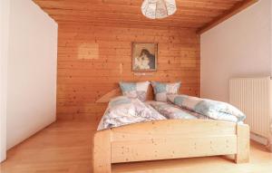 a bedroom with a bed in a wooden wall at Beautiful Home In Ebbs With House A Panoramic View in Rettenschöss