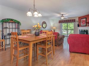 een eetkamer en een woonkamer met een tafel en stoelen bij Riverside Dream Cedar Lodge 103 in Pigeon Forge