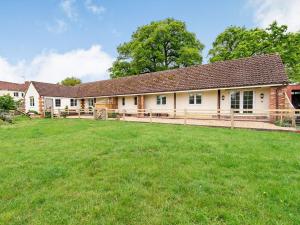 an exterior view of a house with a large yard at Orchard Barns in North Nibley