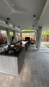 a large outdoor kitchen with a counter and a table at Fu Wan Cafe Villa in Donggang