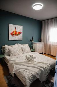 a bedroom with a bed and a blue wall at Boho-Chic-Wohnung Neusiedl in Neusiedl am See