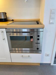a stainless steel oven in a kitchen next to a counter at Carpe diem in Balingen