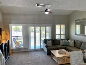 a living room with a couch and a table at 10 H Two Bedroom Condo in Destin