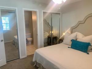 a bedroom with a bed with a blue pillow on it at 10 H Two Bedroom Condo in Destin
