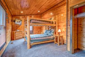 una camera con 2 letti a castello in una baita di tronchi di Standing Bear Lodge, 5 Bedrooms, Sleeps 18, Pool Table, Air Hockey, Hot Tub a Gatlinburg