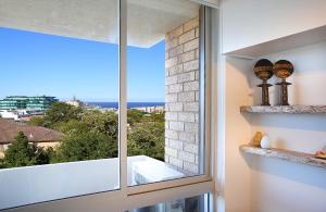 a window with a view of the ocean at Bondi Aqua Vista - Walk to beach and shops in Sydney