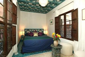 Un pat sau paturi într-o cameră la Riad Aladdin
