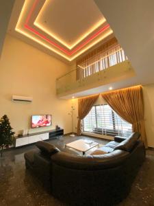 a living room with a couch and a tv at Mariaddo homes in Accra