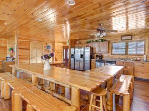 a large wooden kitchen with a large wooden table at Family Ties Lodge in Gatlinburg