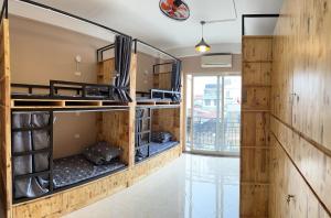 a room with bunk beds in a building at Fortune Homestay in Hanoi