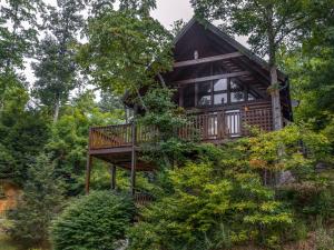 a tree house in the woods with a deck at Trail’s End, 2 Bedrooms, Hot Tub, Jetted Tub, Gas Fireplace, Sleeps 8 in Gatlinburg