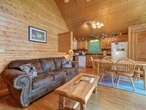 a living room with a couch and a table and a kitchen at Trail’s End, 2 Bedrooms, Hot Tub, Jetted Tub, Gas Fireplace, Sleeps 8 in Gatlinburg