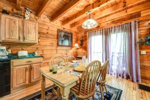 a dining room with a table and chairs in a cabin at Cherished Memories, 2 Bedrooms, Sleeps 6, Jetted Tub, Near Golf Course in Gatlinburg