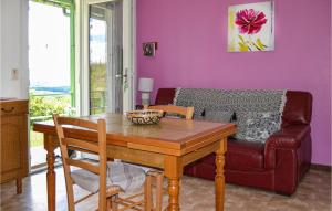 a living room with a table and a couch at Stunning Home In St, Bressou With 2 Bedrooms in Saint-Bressou