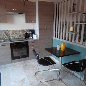 a kitchen with a table and chairs in it at Villa Castellane in Bauduen