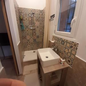 a small bathroom with a sink and a shower at Villa Castellane in Bauduen