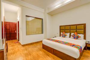 a bedroom with a large bed in a room at FabHotel Shimla Resort in Lucknow