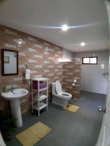 a bathroom with a toilet and a sink at Seaview Hill (Family room with private Pool) 