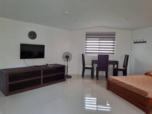 a bedroom with a bed and a table with chairs at Seaview Hill (Family room with private Pool) 