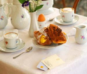 a table with a plate of food and cups of coffee at Hamlet in Dubrovnik