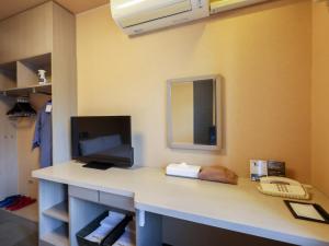 a room with a desk with a computer on it at Dormy Inn EXPRESS Asakusa in Tokyo