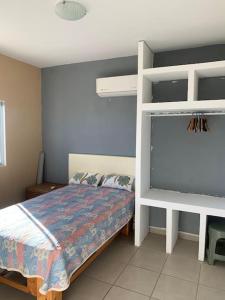 a bedroom with a bed and a white bunk bed at Vista Pacífico Ocean Front in Cabo San Lucas