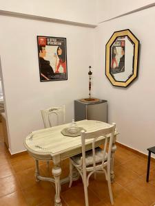 a dining room with a table and a mirror at RITSA ART RESIDENCE in Chania Town