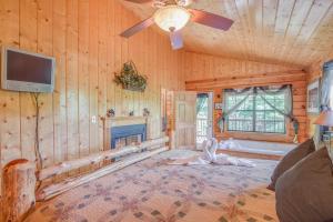 a living room with a ceiling fan and a fireplace at Bear Escape, 1 Bedroom, Sleeps 4, Hot Tub, Pool Table, Jacuzzi Tub in Sevierville