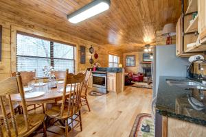 a kitchen and dining room with a table and chairs at Rocky Top Lodge, 6 Bedrooms, Pool Access, Hot Tub, Mountain View, Sleeps 14 in Gatlinburg