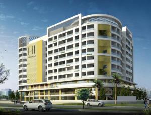 a large building with cars parked in front of it at Hotel Heraa International in Mangalore