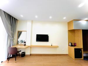 a living room with a tv on a wall at Orion Hotel Halong in Ha Long