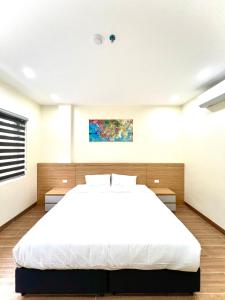 a bedroom with a large white bed in it at Orion Hotel Halong in Ha Long