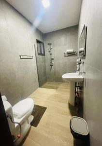 a bathroom with a toilet and a sink at ONYX HOTEL Yamoussoukro in Yamussukro