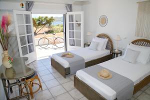 A bed or beds in a room at Aroura Homes 4BR Beachfront Villa