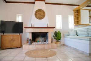A television and/or entertainment centre at Aroura Homes 4BR Beachfront Villa