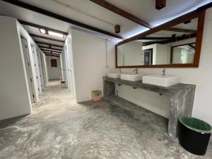 a bathroom with two sinks and two mirrors at Pranee Bungalow in Ko Tao