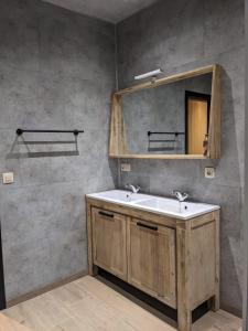 a bathroom with a sink and a mirror at Cosy chalet in nature in Bastogne