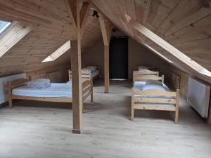 a room with two bunk beds in a attic at Cosy chalet in nature in Bastogne