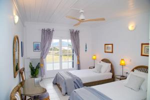 A bed or beds in a room at Aroura Homes 4BR Beachfront Villa