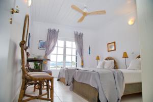 A bed or beds in a room at Aroura Homes 4BR Beachfront Villa