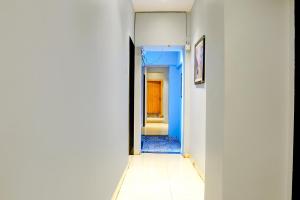 a corridor with a blue and white hallway at FabExpress We Stay in Mumbai