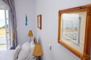 A bed or beds in a room at Aroura Homes 4BR Beachfront Villa