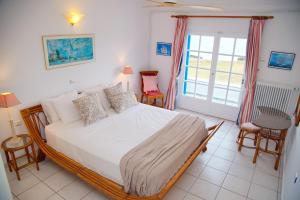A bed or beds in a room at Aroura Homes 4BR Beachfront Villa