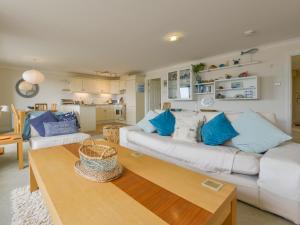 a living room with a white couch and a table at 13 Burgh Island Causeway in Bigbury on Sea