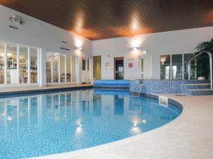 a large swimming pool in a building with a swimming pool at 13 Burgh Island Causeway in Bigbury on Sea